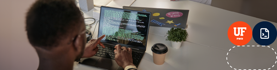 Person typing on keyboard with dual monitors displaying code, symbolizing advanced cybersecurity skills